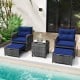 Patio rattan furniture set featuring navy cushions, two ottomans, and a tempered glass coffee table, perfect for.