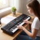 61-key electric portable digital keyboard in black, ideal for beginners, featuring dual speakers and lightweight design.