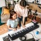 61-key foldable electronic piano keyboard in black, showcasing dual keyboard and MIDI function for versatile music.