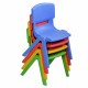 Colorful stackable plastic children chairs in blue, red, yellow, and green, perfect for playrooms and daycare settings.