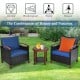 Patio rattan furniture set with blue cushions, acacia wood frame, and coffee table for outdoor relaxation.