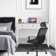 Black ergonomic office chair positioned beside a stylish white side sofa table with three drawers, enhancing workspace.