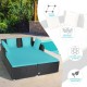 Spacious outdoor rattan daybed in turquoise with upholstered cushions and pillows, perfect for comfortable lounging by.