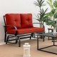 Brick red cushioned patio glider loveseat with ergonomic armrests, perfect for outdoor relaxation in gardens or patios.