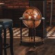 Globe wine cabinet with vintage pattern, sturdy MDF and solid wood legs, featuring wheels for easy movement and storage.