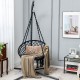 Cushioned black hammock swing chair with inclined backrest and tassels, perfect for indoor or outdoor relaxation.