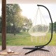 Hammock frame stand in black, featuring a heavy-duty design for indoor and outdoor use, shown in a sunlit setting.