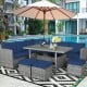 7-piece patio rattan dining set featuring navy cushions, a table, and ottomans, perfect for outdoor relaxation by the.
