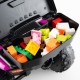 Colorful building blocks stored in the compartment of a pink 6V kids ride-on ATV with music and spray function.