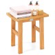 Teak shower bench with towels and toiletries, ideal for shaving legs and adding elegance to any space.