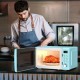 Retro green 700W countertop microwave oven with a rotating glass plate and LED display, ideal for small spaces.