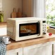 Cream white retro countertop microwave oven with 5 power levels and LED display, perfect for small kitchens and.