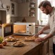 Cream white 700W retro countertop microwave oven with 5 power levels, shown in a kitchen setting, ideal for small.