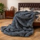 Soft plush gray faux wolf fur blanket draped over a bed, perfect for sofas and cozy relaxation.