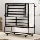 Folding bed with mattress in a compact design, featuring a heavy-duty metal frame and rolling casters for easy storage.