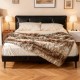 Soft plush fuzzy luxury faux raccoon fur blanket draped over a bed, perfect for warmth and comfort.