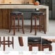 Backless swivel bar stool with padded PU leather seat, rubber wood legs, and footrest for comfortable kitchen seating.