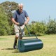 Green 24 x 13 inch metal push lawn roller with foldable handles, ideal for leveling and smoothing lawns.