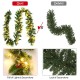 9-foot pre-lit Christmas garland with red berries, featuring 50 LED lights for vibrant indoor and outdoor holiday decor.