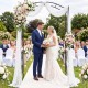 Heavy-duty metal garden arbor with curved roof, perfect for weddings and outdoor events, supporting climbing plants.