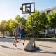 Height adjustable basketball goal system with shatterproof backboard, portable design, and anti-tip base for stability.