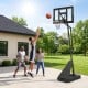 Height adjustable basketball goal system with shatterproof backboard, set at 7.7 ft for outdoor play and stability.