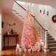 Snow-flocked 7 FT pink Christmas tree with 140 warm white LED lights, perfect for holiday decoration in any space.