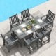 7-piece grey patio dining set with HDPE table and chairs, featuring a large tabletop and rustic wood-like surface.