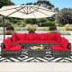 Sectional patio rattan sofa set with red cushions and coffee table, perfect for outdoor relaxation and gatherings.