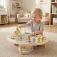 Toddler playing with a 7-in-1 Montessori activity table featuring a bead maze, xylophone, and shape sorter for sensory.