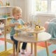 Toddler playing at a 7-in-1 Montessori activity table with musical features, promoting sensory and early learning.