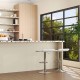 Mid-century dining set featuring adjustable white PU leather bar stools and a glass dining table in a modern kitchen.
