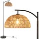 Arc floor lamp with a black pole and woven hanging lampshade, ideal for living rooms and bedrooms.