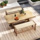 Teak wood patio bench with weave seat, solid wood legs, ideal for outdoor spaces, comfortably seats three people.