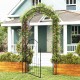 Metal garden arch with gate, featuring an arched design and climbing trellises, perfect for decorative outdoor.