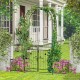 Garden arbor with lockable gate and side planters, made of premium metal, ideal for enhancing outdoor spaces.
