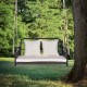 Wicker hanging porch swing with white cushions, designed for 2 people, suitable for outdoor use in gardens or backyards.
