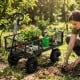 Utility wagon with removable mesh sides, filled with plants and gardening tools, perfect for outdoor gardening tasks.