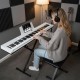 Electric piano keyboard with adjustable stand, featuring light-up buttons and MIDI function for easy learning and.