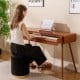 88-key graded hammer action electric piano in brown, used as a desk, featuring a push-pull drawer and music stand.