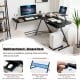 L-shaped black computer desk with removable monitor stand and pull-out keyboard tray, ideal for home office use.
