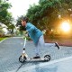Adjustable white kick scooter with 8" wheels, ergonomic handle, and folding design, perfect for commuting and kids.