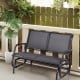 Gray swing glider chair with curved backrest and armrests, perfect for relaxing in outdoor patios or backyards.