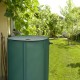 Collapsible 60-gallon rain barrel in green, made of durable PVC, ideal for water collection in gardens.