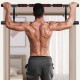 Foldable pull-up bar with foam grip, shown in use for chin-ups, designed for home gym convenience and stability.