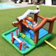Inflatable kids bounce house featuring a slide, climbing wall, and ball pit for outdoor fun in the backyard.