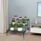Ladder-style three-tier metal plant stand with decorative patterns, offering ample space for various plants indoors or.