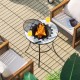 Round fire pit table with mesh cover, featuring a durable steel frame, ideal for outdoor gatherings on the patio.