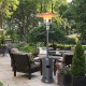 Outdoor propane heater with table and wheels in gray, providing warmth for patio gatherings and ensuring safety with.