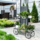 6-tier garden cart flower rack with metal structure, showcasing potted plants, ideal for outdoor patio decoration.